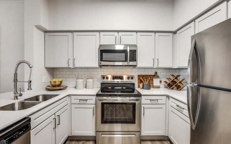 a kitchen with white cabinets