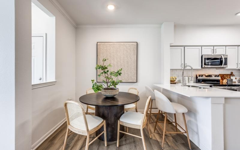 a dining room with a table and chairs